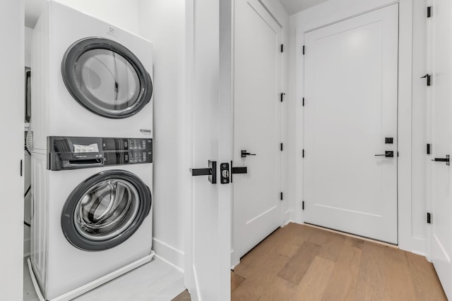 2176 Carson St Unit 5, Nashville, TN 37211 - clothes washing area with light wood-type flooring, baseboards, laundry area, and stacked washer / dryer