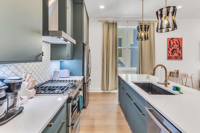 2176 Carson St Unit 5, Nashville, TN 37211 - kitchen featuring light wood-style flooring, a sink, wall chimney exhaust hood, light countertops, and appliances with stainless steel finishes