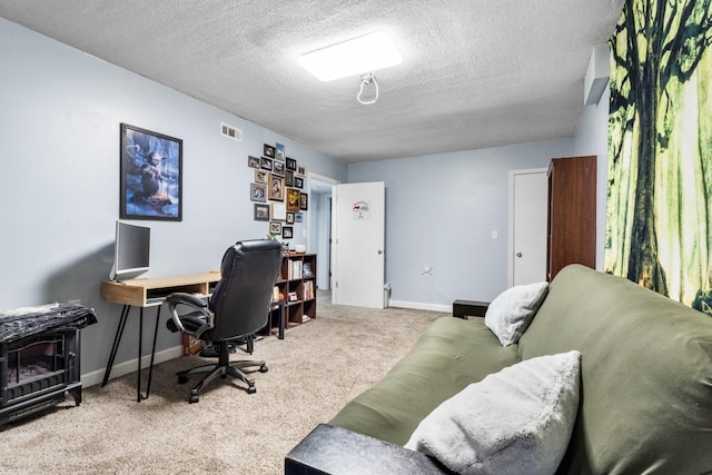460 Seven Springs Rd, Clarksville, TN 37043 - home office with a textured ceiling, baseboards, visible vents, a wood stove, and carpet floors