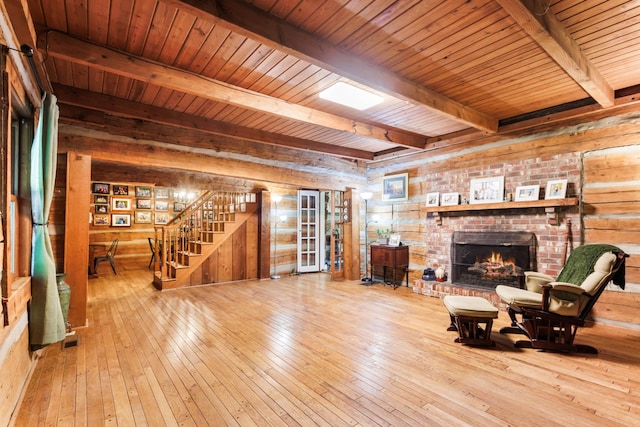460 Seven Springs Rd, Clarksville, TN 37043 - living room with wood-type flooring, a brick fireplace, beamed ceiling, and stairs