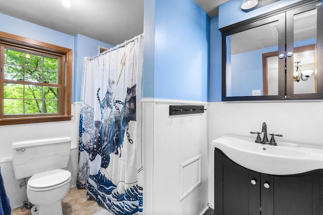 460 Seven Springs Rd, Clarksville, TN 37043 - bathroom featuring toilet, a shower with curtain, vanity, and a wainscoted wall
