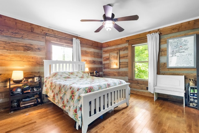 460 Seven Springs Rd, Clarksville, TN 37043 - bedroom featuring hardwood / wood-style flooring, wooden walls, and a ceiling fan