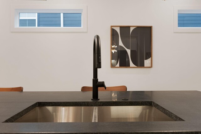 interior details with dark countertops and a sink