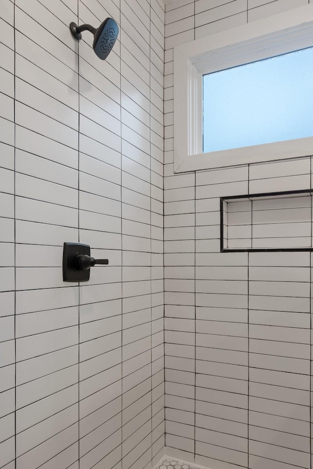 bathroom with a tile shower