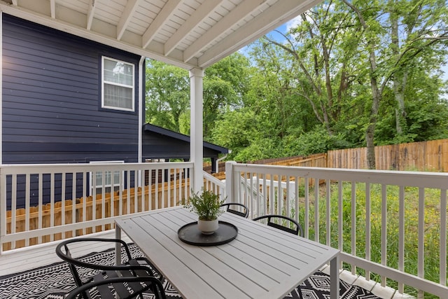 wooden terrace with fence and outdoor dining space
