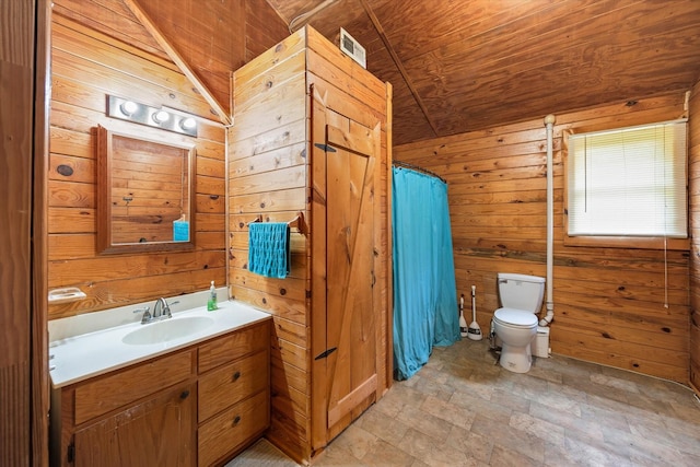 bathroom with toilet, vanity, stone finish floor, vaulted ceiling, and wooden walls