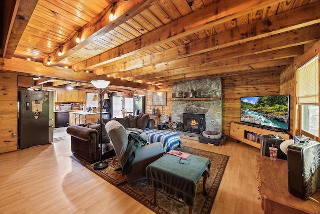 living room with wooden ceiling, wood walls, beam ceiling, and light wood-style floors