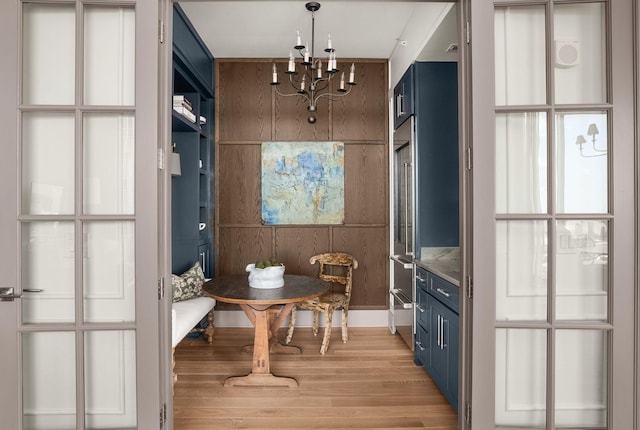 interior space featuring light wood-style floors and a chandelier