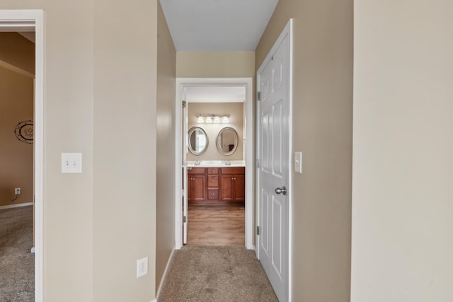 corridor with carpet flooring and baseboards