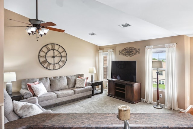 living area with a ceiling fan, baseboards, visible vents, vaulted ceiling, and light carpet