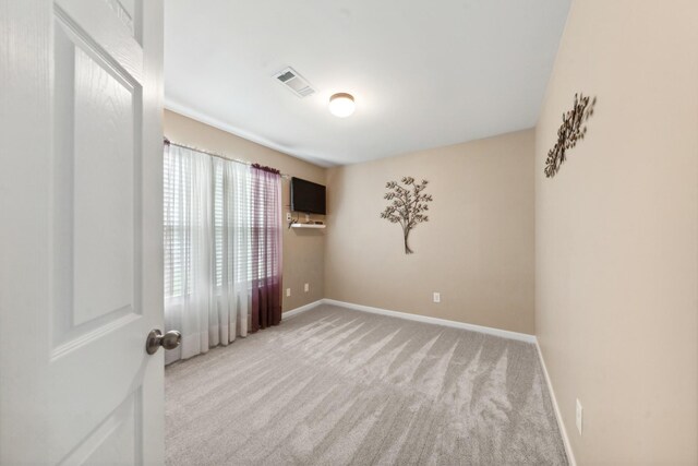 unfurnished room with baseboards, carpet flooring, and visible vents