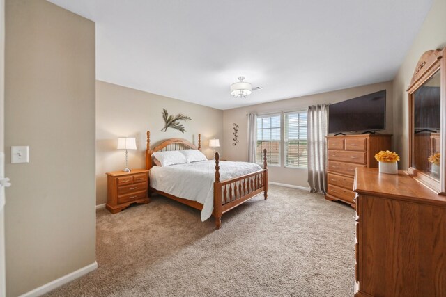 carpeted bedroom featuring baseboards