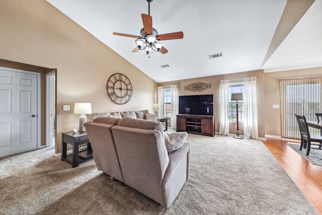 carpeted living room featuring high vaulted ceiling, baseboards, a ceiling fan, and visible vents