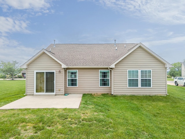 rear view of property with a lawn, a patio area, and roof with shingles