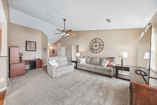 living area with a ceiling fan, visible vents, carpet floors, and vaulted ceiling
