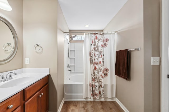 full bath with baseboards, shower / tub combo with curtain, vanity, and wood finished floors