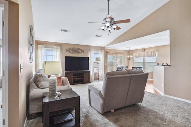 carpeted living room featuring a wealth of natural light, visible vents, and a ceiling fan