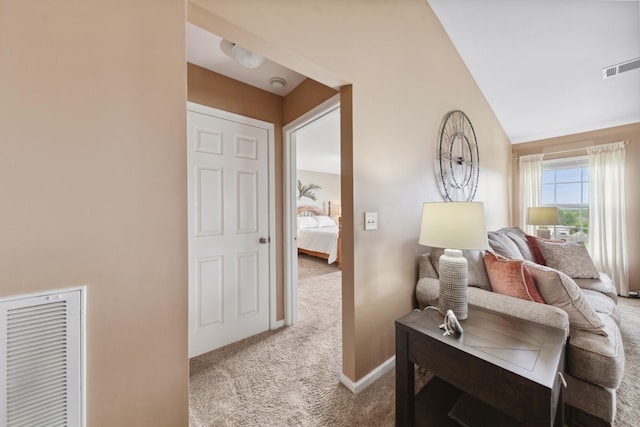 sitting room featuring baseboards, carpet flooring, visible vents, and vaulted ceiling