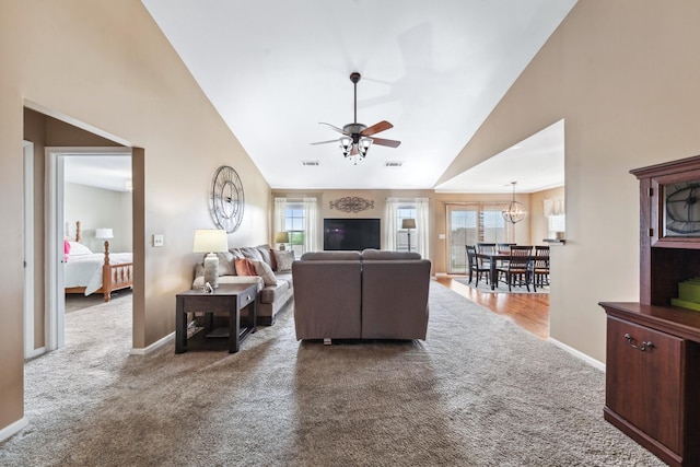 living area with a ceiling fan, visible vents, high vaulted ceiling, and carpet floors