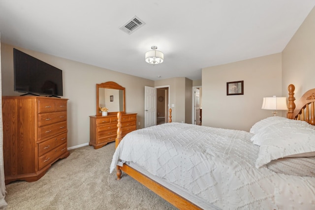 bedroom with visible vents, baseboards, and light carpet