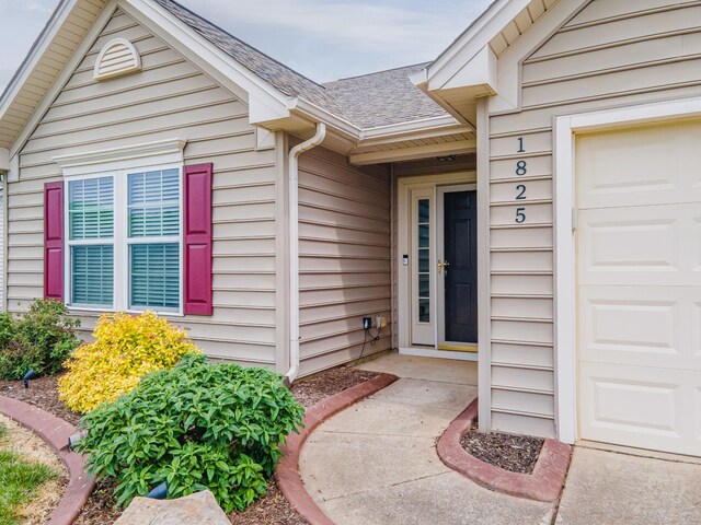 entrance to property with roof with shingles