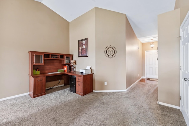 office area with lofted ceiling, baseboards, and carpet