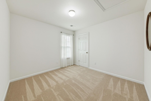 empty room with baseboards, visible vents, and carpet floors