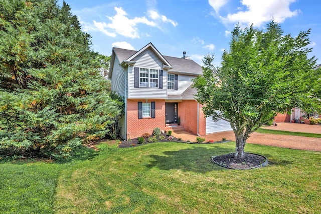 view of front of property featuring brick siding, a front lawn, and a garage