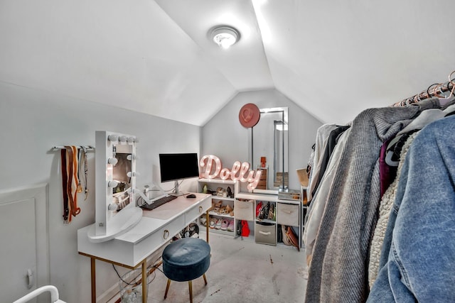 home office with vaulted ceiling and unfinished concrete floors