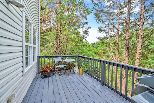 wooden deck with a fire pit