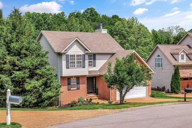 view of front of house with a garage, a chimney, brick siding, and driveway