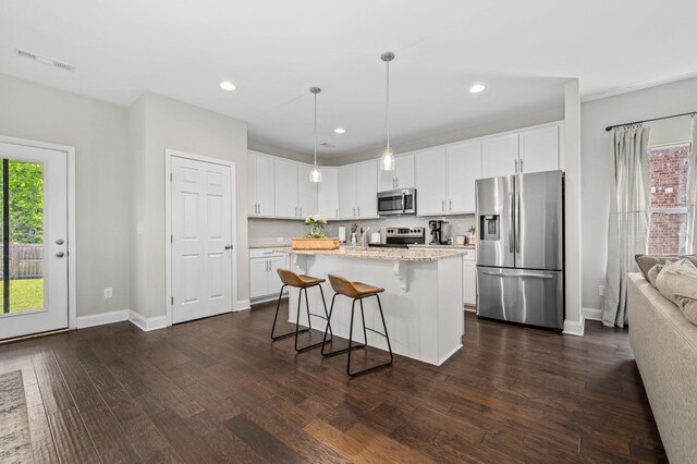 567 Oakvale Ln, Mount Juliet, TN 37122 - kitchen featuring appliances with stainless steel finishes, dark wood-type flooring, a kitchen bar, white cabinetry, and recessed lighting