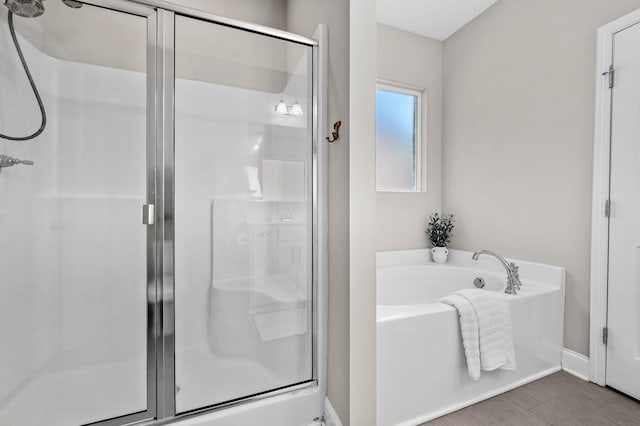 567 Oakvale Ln, Mount Juliet, TN 37122 - full bathroom with a shower stall, a bath, baseboards, and wood finished floors