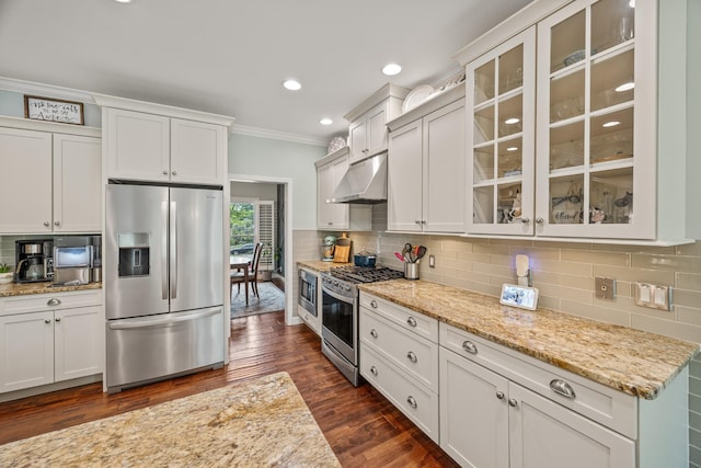kitchen featuring under cabinet range hood, ornamental molding, stainless steel appliances, and decorative backsplash