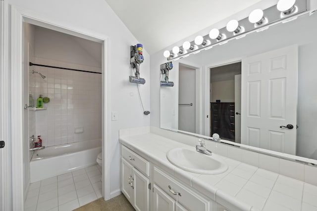 bathroom with lofted ceiling, shower / bathtub combination, toilet, tile patterned floors, and vanity