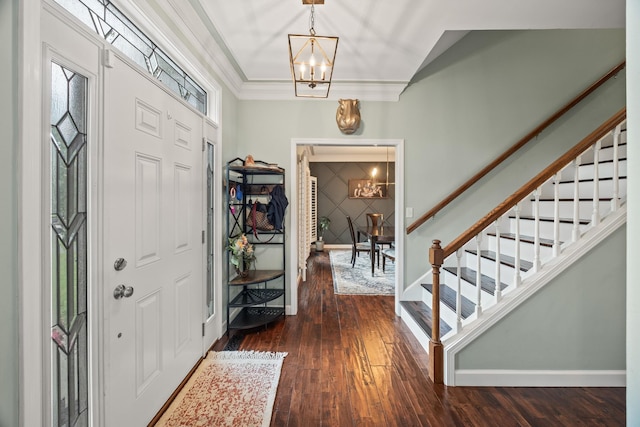 foyer entrance featuring a chandelier, stairs, dark wood-style flooring, and baseboards