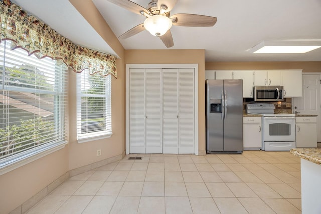 2004 Pinewood Ct, Mount Juliet, TN 37122 - kitchen with stainless steel appliances, plenty of natural light, white cabinets, a ceiling fan, and vaulted ceiling