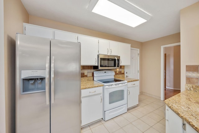 2004 Pinewood Ct, Mount Juliet, TN 37122 - kitchen featuring stainless steel appliances, decorative backsplash, light tile patterned flooring, white cabinets, and baseboards