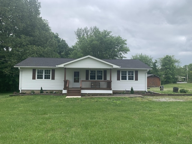 single story home with a porch, roof with shingles, and a front lawn