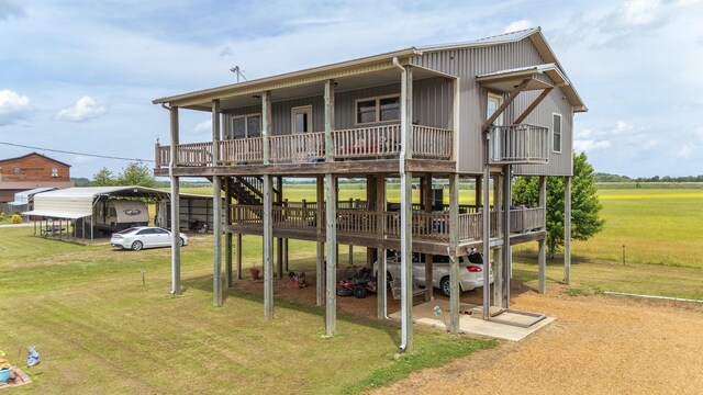 2175 Catfish Ln, Crump, TN 38327 - rear view of house with a yard, dirt driveway, a deck, and a detached carport