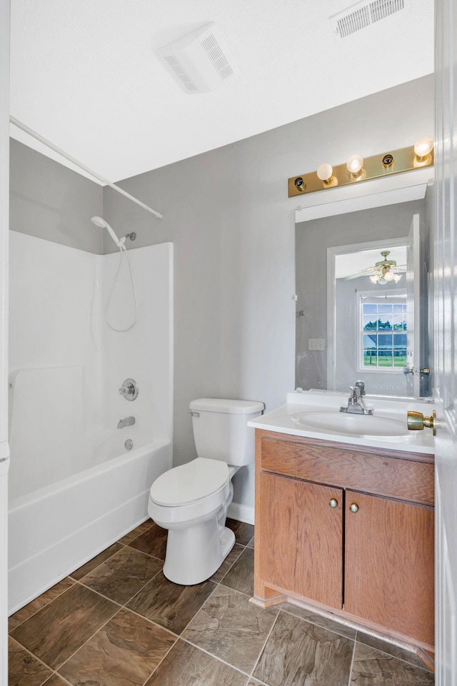 bathroom with toilet,  shower combination, vanity, and visible vents