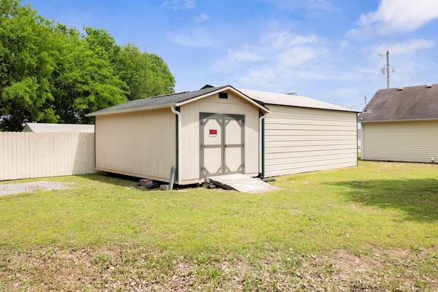 view of shed featuring fence