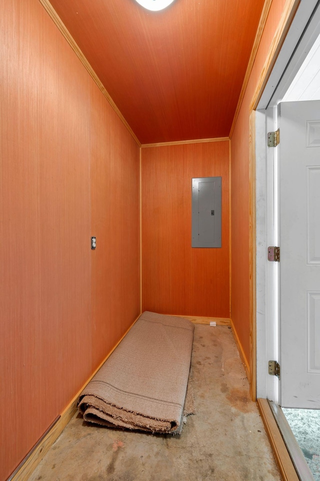 interior space featuring wood ceiling, concrete flooring, wood walls, and electric panel