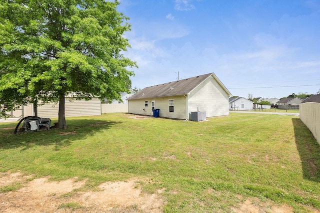 view of yard featuring central AC unit and fence