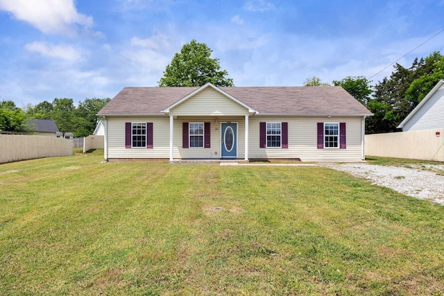 ranch-style house with a porch, roof with shingles, fence, and a front lawn