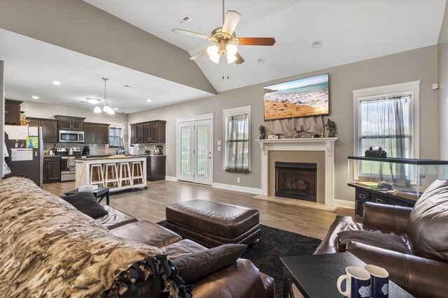 2950 Jim Taylor Rd, Woodlawn, TN 37191 - living room with light wood-type flooring, lofted ceiling, a ceiling fan, and a fireplace