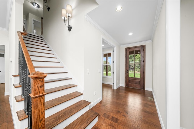 foyer with hardwood / wood-style flooring, recessed lighting, stairway, crown molding, and baseboards