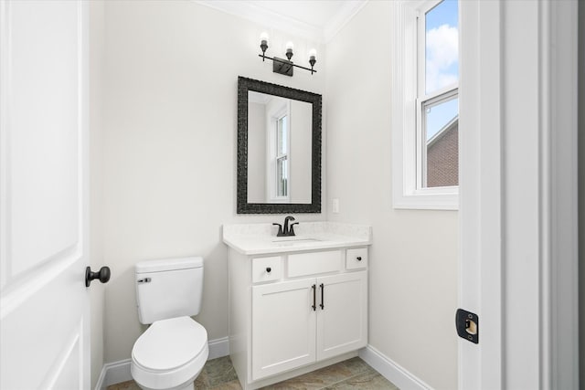 bathroom featuring crown molding, toilet, baseboards, and vanity