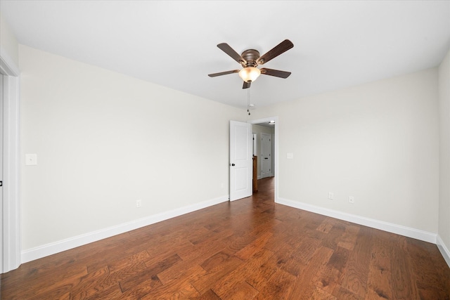 unfurnished room with dark wood finished floors, baseboards, and ceiling fan