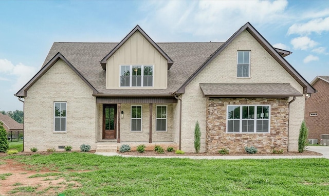 craftsman inspired home featuring a shingled roof, board and batten siding, a front yard, and stone siding